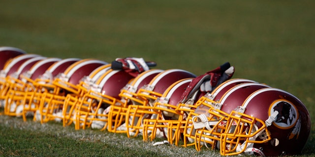 Aug. 4, 2009: Washington Redskins helmets are displayed on the field during NFL football training camp at Redskins Park in Ashburn, Va. (AP/Pablo Martinez Monsivais, File)