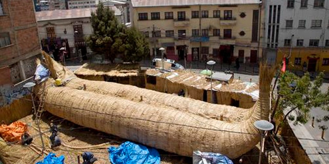 Workers continue construction of a reed boat named the "Viracocha III," and built by Bolivian Aymara Indians, in La Paz, Bolivia, Wednesday, Oct. 19, 2016. American explorer Phil Buck is preparing to cross the Pacific Ocean from South America to Australia in the Viracocha III, a three-masted boat that was made from several tons of dried reeds of the totora plant. The expedition seeks to prove that ancient mariners could have made such journeys across huge ocean expanses in reed ships, and that such vessels could have been a factor in human migration. (AP Photo/Juan Karita)