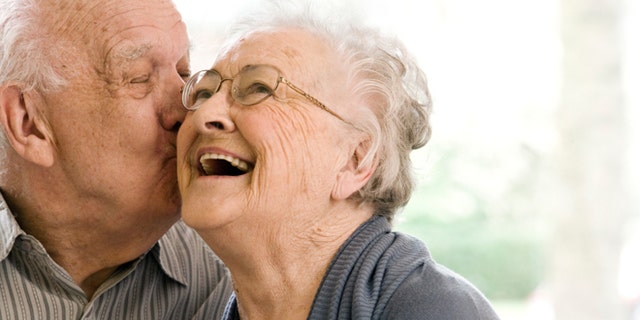 Elderly Man and Woman on Couch in Nursing Home
