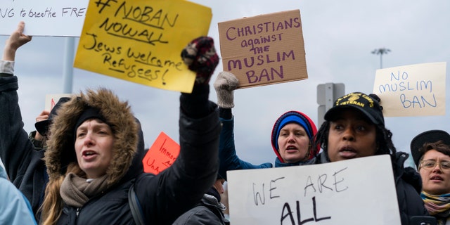 Protesters assemble at JFK Airport after two Iraqi refugees were detained.