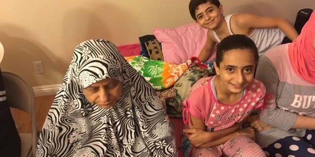 Mahmoud'wife, Hand, with grandchildren Mohamed and Shahed.