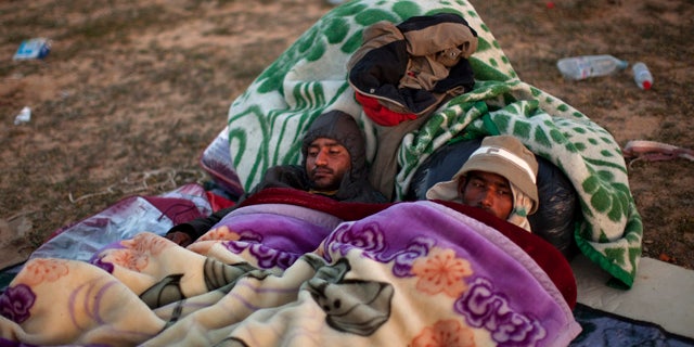 March 7: Men from Bangladesh, who used to work in Libya but recently fled the unrest, rest as they wait for their buses to be repatriated to their country, at a refugee camp at the Tunisia-Libya border, in Ras Ajdir, Tunisia. A top aid official says more than 213,000 foreign workers have fled Libya's violence and hundreds of thousands more are struggling to get out. The exodus is creating a humanitarian crisis across the border with Tunisia - another North African country in turmoil after an uprising in January that ousted its longtime leader. (AP)