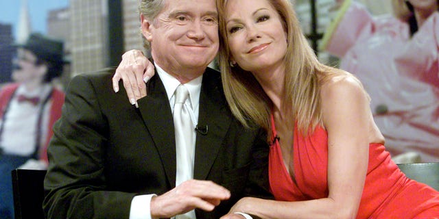 Talk show host Kathie Lee Gifford (R) hugs her co-host Regis Philbin during Gifford's final appearance on their popular morning show 