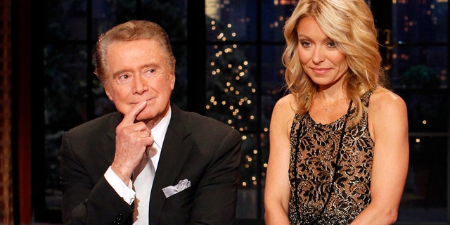 Regis Philbin says goodbye with co-host Kelly Ripa during his final show of on "Live With Regis and Kelly" in New York, November 18, 2011. 