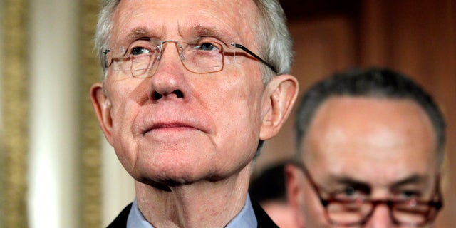 Senate Majority Leader Harry Reid of Nev., left, pauses during a news conference on Capitol Hill in Washington, Friday, April 8, 2011. (AP)