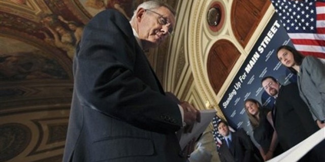Senate Majority Leader Harry Reid of Nev. , looks at signed petition papers on a table in support of a strong financial reform, during a news conference discussing Wall Street accountability legislation, Wednesday, May 5, 2010, on Capitol Hill. (AP)