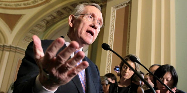 Senate Majority Leader Harry Reid of Nev. speaks with reporters about the conflicting plans to deal with the debt crisis, Tuesday, July 26, 2011, on the Hill Capitol in Washington.