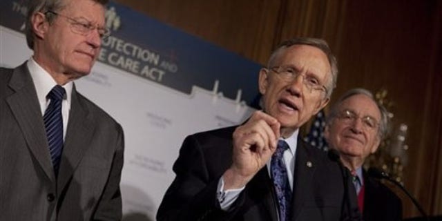 Senate Majority Leader Harry Reid, center, along with Sen. Max Baucus, left, and Sen. Tom Harkin, gestures during a health care news conference on Capitol Hill Dec. 21. (AP Photo)