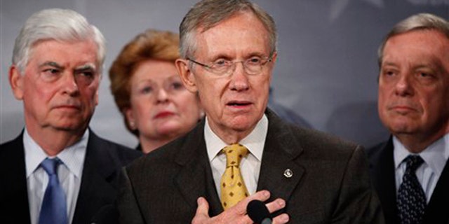 Senate Majority Leader Harry Reid, D-Nev., second right, with Sens. Chris Dodd, D-Conn., left, Debbie Stabenow, D-Mich., second left, and Dick Durbin, D-Ill., right, speaks to the media about the Democratic health care bill on Capitol Hill Nov. 18. (AP Photo)