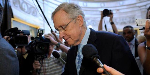 Senate Majority Leader Harry Reid is followed by reporters as he walks through the Capitol Rotunda on Capitol Hill July 31.