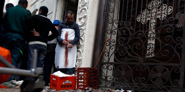 Egyptian Christians gather outside the Coptic Orthodox church after a car bomb attack, in Egypt's northern city of Alexandria, January 1, 2011.