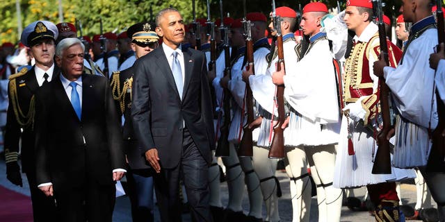 US President Barack Obama and his greek counterpart Prokopis Pavlopoulos review the Presidential Guard in Athens, Tuesday, Nov. 15, 2016. President Barack Obama arrived in Greece Monday morning on the first stop of his final foreign tour as president, the first visit to Greece by a sitting U.S. president since Bill Clinton in 1999 trip. (AP Photo/Lefteris Pitarakis)