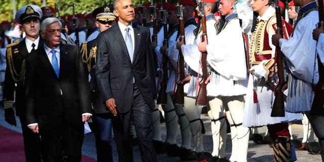US President Barack Obama and his greek counterpart Prokopis Pavlopoulos review the Presidential Guard in Athens, Tuesday, Nov. 15, 2016. President Barack Obama arrived in Greece Monday morning on the first stop of his final foreign tour as president, the first visit to Greece by a sitting U.S. president since Bill Clinton in 1999 trip. (AP Photo/Lefteris Pitarakis)