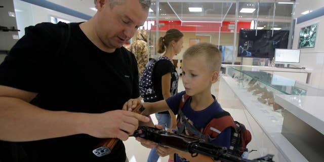 Kalashnikov, whose AK-47 assault rifle has armed Russian forces for 70 years and been the preferred weapon of insurgents across continents, has opened a store at Moscow's Sheremetyevo airport selling souvenirs including plastic model guns, the company said.