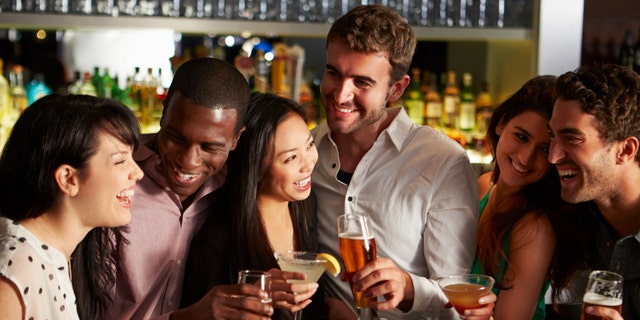 Group Of Friends Enjoying Drink In Bar