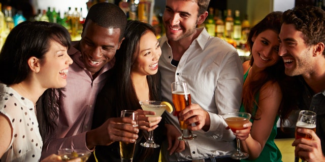 Group Of Friends Enjoying Drink In Bar