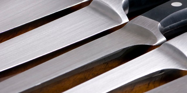 A close up shot of high quality kitchen knives on a cutting board