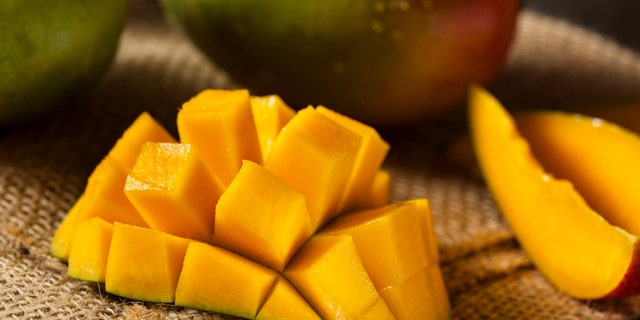 Organic Colorful Ripe Mangos on a Background