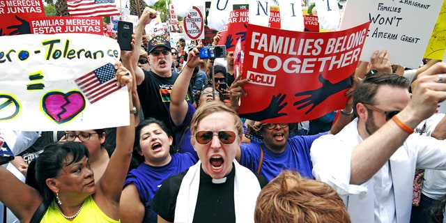 In this June 28 photo, protesters chant, "Families belong together!" as they walk to the front doors of the federal courthouse in Brownsville, Texas.