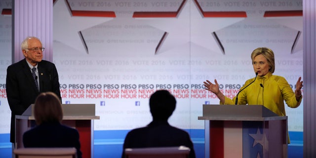 Democratic U.S. presidential candidate former Secretary of State Hillary Clinton speaks as Senator Bernie Sanders listens at the PBS NewsHour Democratic presidential candidates debate in Milwaukee, Wisconsin, February 11, 2016. REUTERS/Jim Young - RTX26KQQ