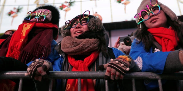 Revelers watch rehearsals of New Year's celebrations in Times Square, New York City, Dec. 31, 2017.