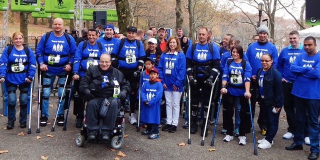 ReWalk inventor Dr. Amit Goffer (bottom row) and other ReWalkers participate in a 5K walk in New York City's Riverside Park.