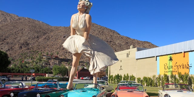 Public Square downtown Palm Springs with Marilyn Monroe scupture and early model convertibleThunderbirds. Brilliant blue Palm Springs Sky in the background. All from the same era. Marilyn is the most popular tourist attraction in the town.
