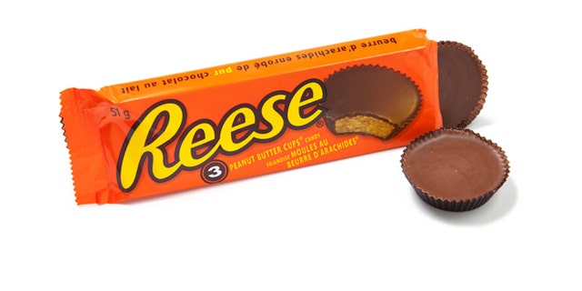 Toronto, Canada - May 10, 2012: This is a studio shot of Reese Peanut Butter Cups candy made by Reese, a subsidiary of The Hershey Company, isolated on a white background.