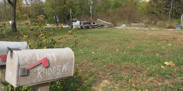In this Tuesday, Oct. 18, 2016 photo, a porch is all that remains of the home on Union Hill Road after investigators removed the trailer where the bodies of Clarence "Frankie" Rhoden and Hannah Gilley were found on April 22, two of eight family members found shot to death that day in a still-unsolved crime, in Piketon, Ohio. (AP Photo/Andrew Welsh-Huggins)