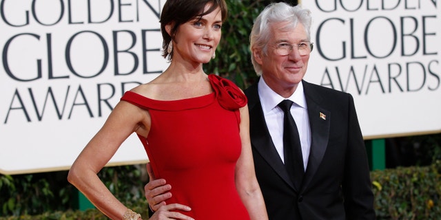 Actor Richard Gere and his wife, Carey Lowell, arrive at the 70th annual Golden Globe Awards in Beverly Hills, California, January 13, 2013.