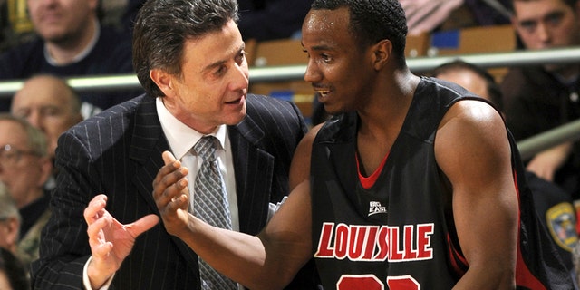 Louisville coach Rick Pitino, left, talks with guard Andre McGee during the first half of an NCAA college men's basketball game against Notre Dame in South Bend, Ind. Feb. 12, 2009.