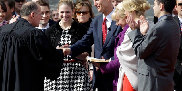 New Florida Gov. Rick Scott, center, surrounded by family members, shakes hands with Florida Supreme Court chief justice Charles Canady after taking the oath of office Tuesday, Jan. 4, 2011 in Tallahassee, Fla. (AP)