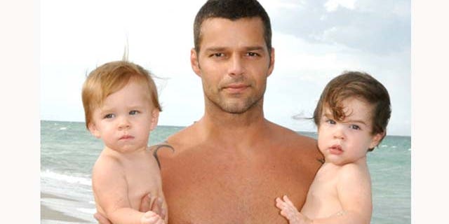 In this handout image provided by Ricky Martin, Ricky Martin poses with his sons Valentino and Matteo on August 18, 2009 in Miami, Florida.