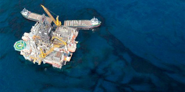 Oil floats around a rig at the site of the Deepwater Horizon oil spill in the Gulf of Mexico May 31. (AP Photo)