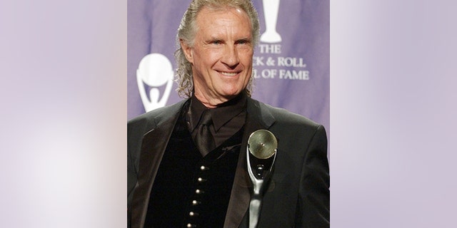 In this March 10, 2003 file photo, Bill Medley, one half of the famed Righteous Brothers singing duo, poses for photographers after being inducted into the Rock and Roll Hall of Fame in New York.