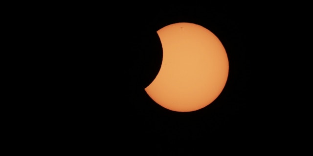 May 10, 2013: The moon begins to cross in front of the sun during a partial solar eclipse in Sydney.