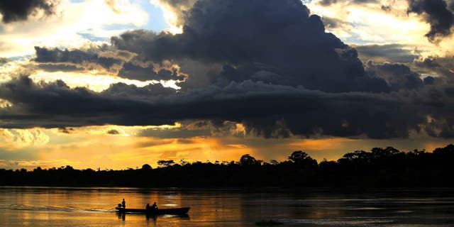 IQUITOS, PERU - JUNE 08: A view of the Northern Peruvian Amazon River on June 8, 2007 from the town of Nauta to the town of Trometeros, Peru. This pristine river and massive rainforest is under threat from infrastructure development in Peru. The Achuar Indian people of this Northern region recently won a legal battle with Argentinian Oil giant PlusPetrol to stop them dumping waste oil water, so called "hot-water" into their water supply. The amount is estimated at around 500 000 barrels a day over a period of 30 years. This has played havoc with the eco-systems around the town of Trompeteros. The oil company has yet to make good on its promises for payment and transparency. The oil company provides the bulk of employment for the polluted town of Trompeteros and thus has the local Achuan population under pressure to not pay attention to the pollution levels. The Achuan people are faced with a choice between a centuries old sustainable lifestyle in harmony with the environment or a move towards increased devastation of their natural lands in the Amazon basin by the oil industry. (Photo by Brent Stirton/Getty Images)