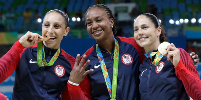 United States' Diana Taurasi, left, Tamika Catchings, center, and Sue Bird, right, celebrate with their gold medals after their win in a women's basketball game against Spain at the 2016 Summer Olympics in Rio de Janeiro, Brazil, Saturday, Aug. 20, 2016. (AP Photo/Eric Gay)