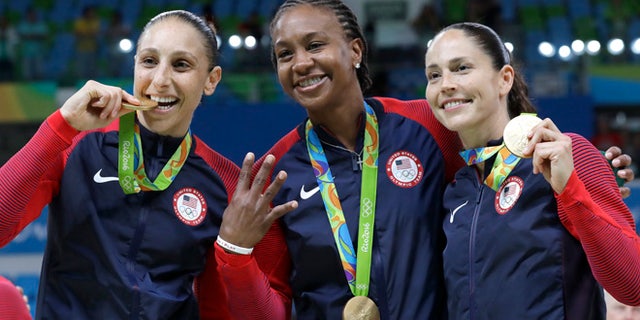 United States' Diana Taurasi, left, Tamika Catchings, center, and Sue Bird, right, celebrate with their gold medals after their win in a women's basketball game against Spain at the 2016 Summer Olympics in Rio de Janeiro, Brazil, Saturday, Aug. 20, 2016. (AP Photo/Eric Gay)