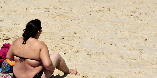 A woman sits on Ipanema beach in Rio de Janeiro August 27, 2010. (BRAZIL - Tags: HEALTH SOCIETY TRAVEL)