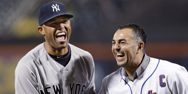 New York Yankees relief pitcher Mariano Rivera, left, laughs with former New York Mets closer John Franco after Franco caught Rivera's ceremonial first pitch before an interleague baseball game at Citi Field in New York, Tuesday, May 28, 2013. (AP Photo/Kathy Willens)