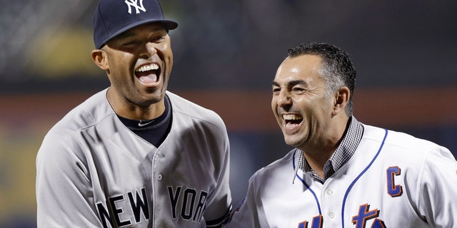 New York Yankees relief pitcher Mariano Rivera, left, laughs with former New York Mets closer John Franco after Franco caught Rivera's ceremonial first pitch before an interleague baseball game at Citi Field in New York, Tuesday, May 28, 2013. (AP Photo/Kathy Willens)