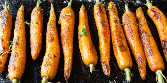 whole roasted carrots with tails, food close up