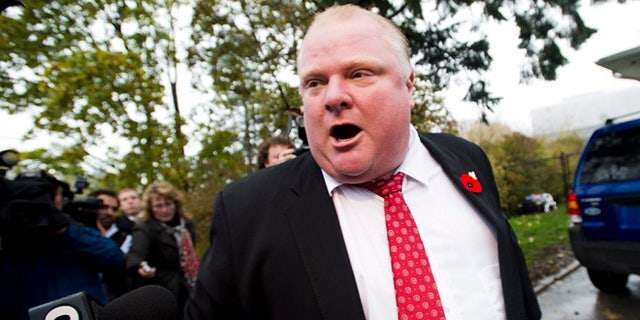Oct. 31, 2013: In this file photo, Toronto Mayor Rob Ford tells to the media to get off his property as he leaves his home in Toronto.