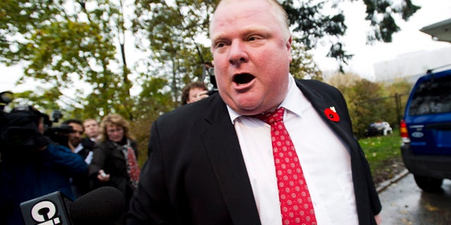Oct. 31, 2013: In this file photo, Toronto Mayor Rob Ford tells to the media to get off his property as he leaves his home in Toronto.