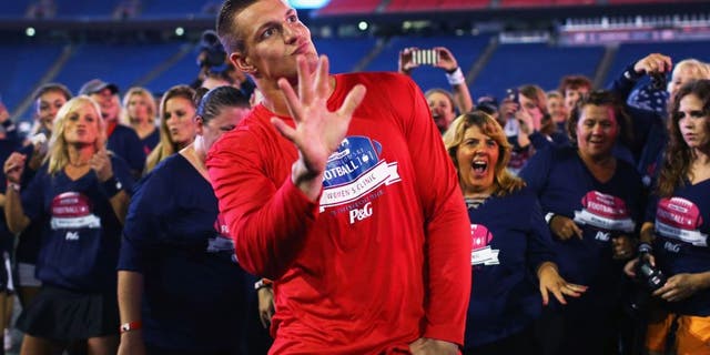 FOXBORO, MA - SEPTEMBER 28: Rob Gronkowski #87 of the New England Patriots dances with clinic participants during The Rob Gronkowski Football 101 Women's Clinic at Gillette Stadium on September 28, 2015 in Foxboro, Massachusetts. The clinic aimed to teach women fundamental football skills and rules of the game. (Photo by Maddie Meyer/Getty Images)