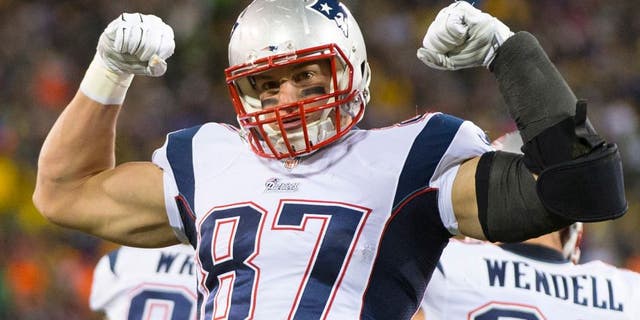 Nov 30, 2014; Green Bay, WI, USA; New England Patriots tight end Rob Gronkowski (87) celebrates following a play during the second quarter against the Green Bay Packers at Lambeau Field. Mandatory Credit: Jeff Hanisch-USA TODAY Sports