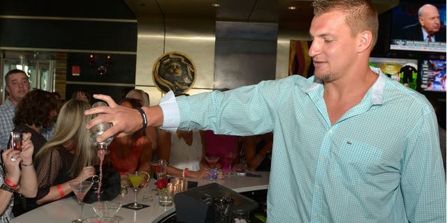 BOSTON, MA - MAY 13: Rob Gronkowski of the New England Patriots serves guests at "Shaking It Up" Event Benefiting The One Fund Boston at Strega Water Front Bar on May 13, 2013 in Boston, Massachusetts. (Photo by Paul Marotta/Getty Images)