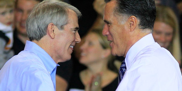 Oct. 25, 2012: In this file photo, Sen. Rob Portman, R-Ohio, left, shakes hands with Republican presidential candidate, former Massachusetts Gov. Mitt Romney after Portman introduced Romney at a campaign stop at defense contractor Jet Machine in Cincinnati.