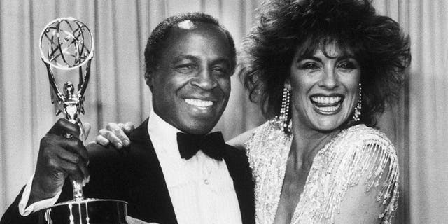 Robert Guillaume accepts his Emmy award for his role on 'Benson' alongside Linda Grey in 1985.